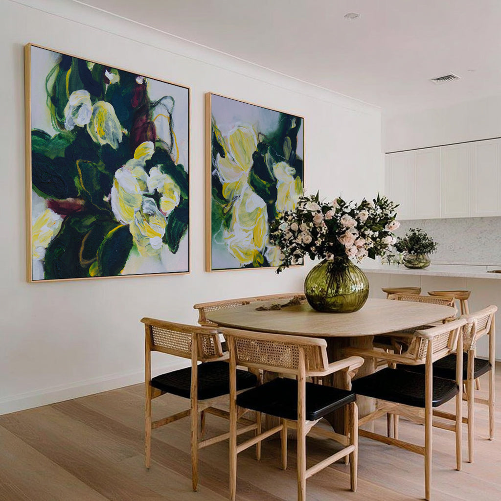 Two extra large printed and framed original artwork of the Canadian artist, Mona showcase side-by-side on a kitchen wall