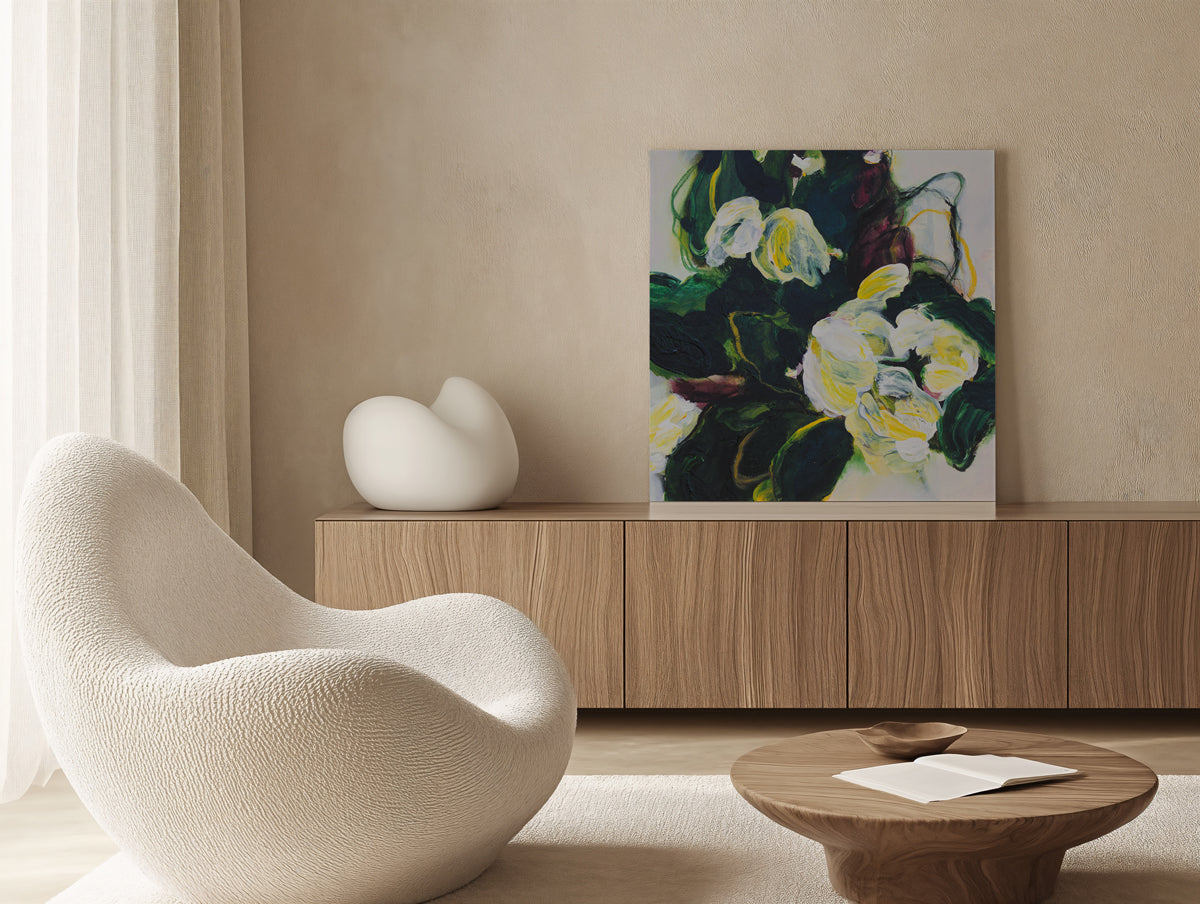 Modern interior with a white chair, wooden cabinet, and floral painting.