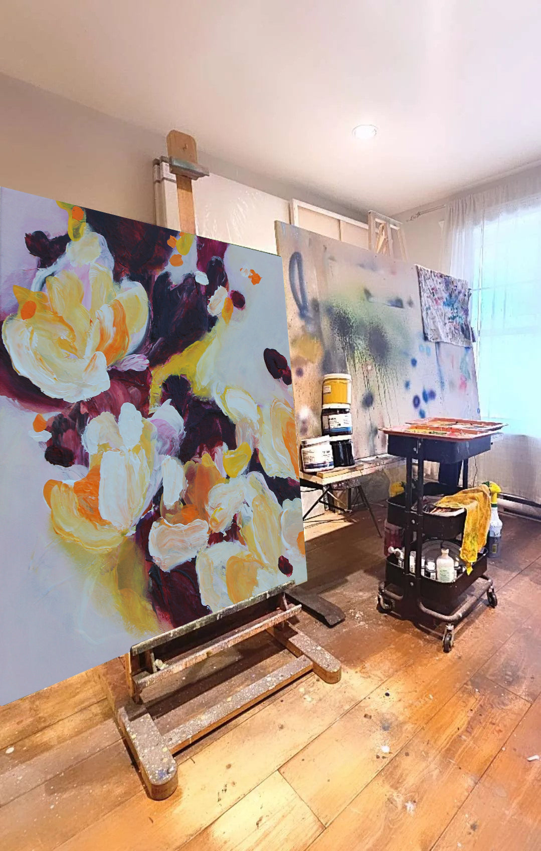 Mona‘s painting in progress in her studio by a window