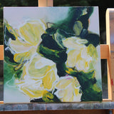 Painting of yellow flowers on a wooden easel outdoors